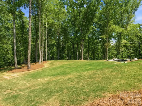 a backyard of a house with large trees