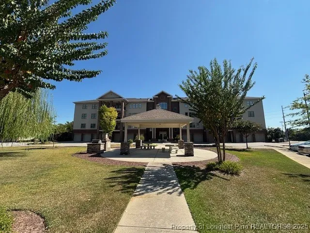 a swimming pool with outdoor seating and yard