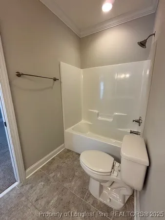 a white toilet sitting next to a bathroom sink and vanity