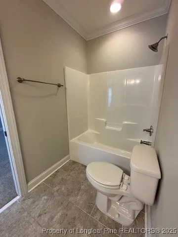 a white toilet sitting next to a bathroom sink and vanity