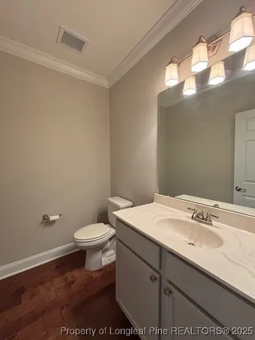 a bathroom with a sink a toilet and mirror