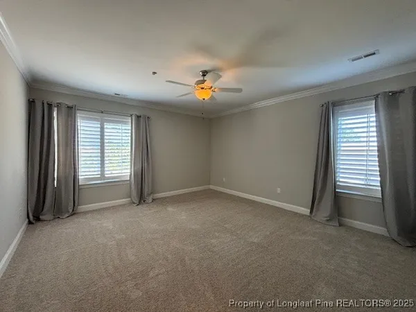 an empty room with closet and a ceiling fan
