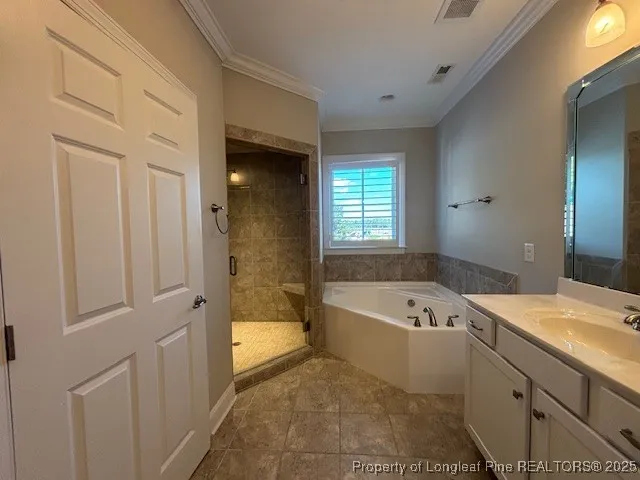 a bathroom with a tub a sink and a window
