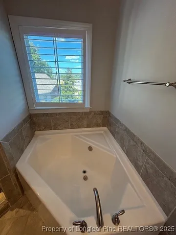a bath tub sitting in a bathroom next to a window