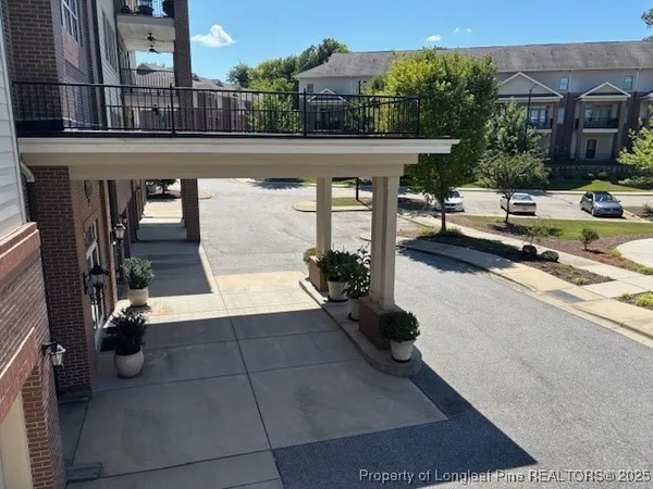 a view of a patio with table and chairs potted plants with wooden floor