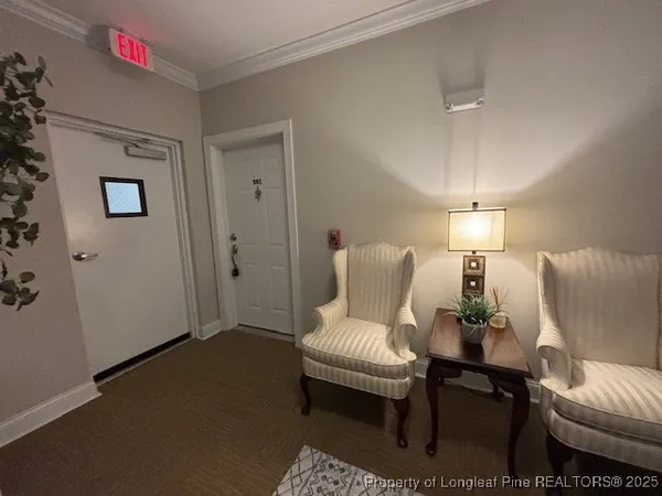 a living room with furniture and a lamp