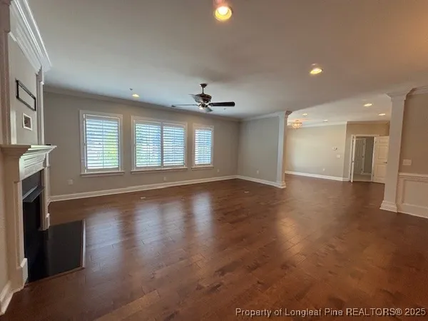 a view of a livingroom with wooden floor and a fireplace