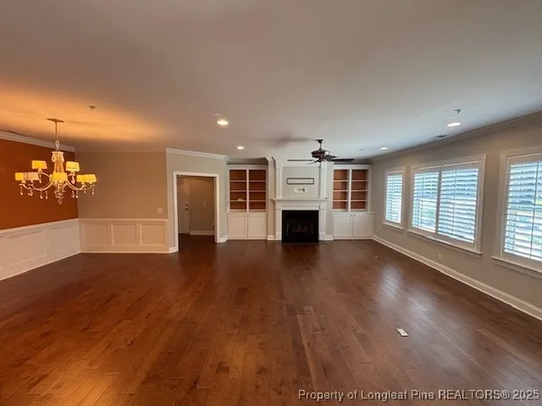 a view of livingroom with hardwood floor and a kitchen