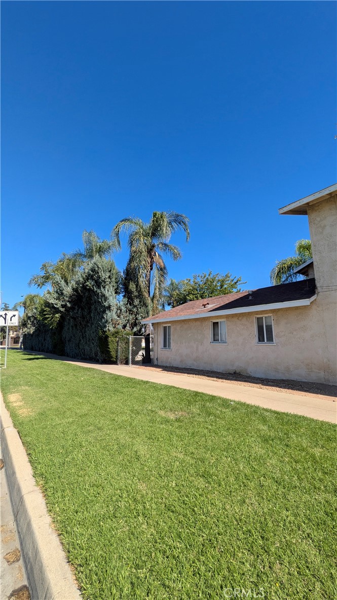 845 East 6th Street, Unit 16 Beaumont, CA 92223 - Photo 14 of 14 a front view of a house with a yard and garage