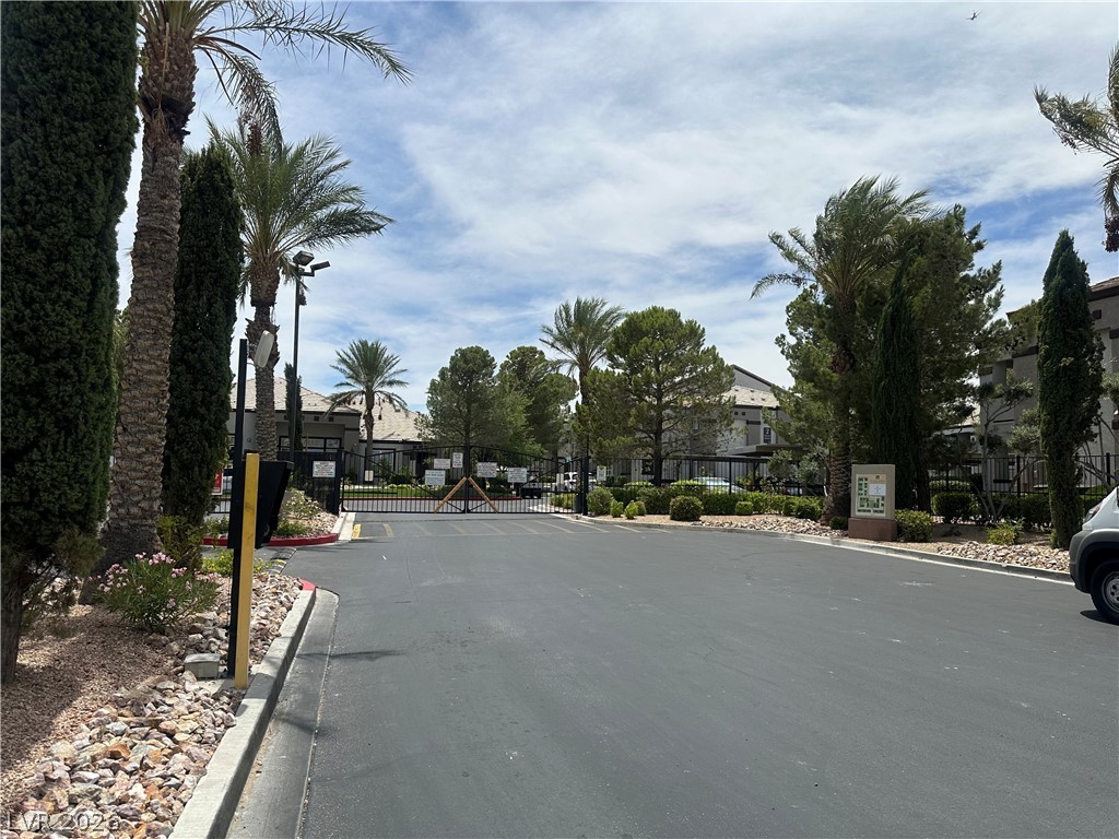 7255 West Sunset Road, Unit 2006 Las Vegas, NV 89113 - Photo 24 of 24 Secure community entrance with lush landscaping and towering palm trees.