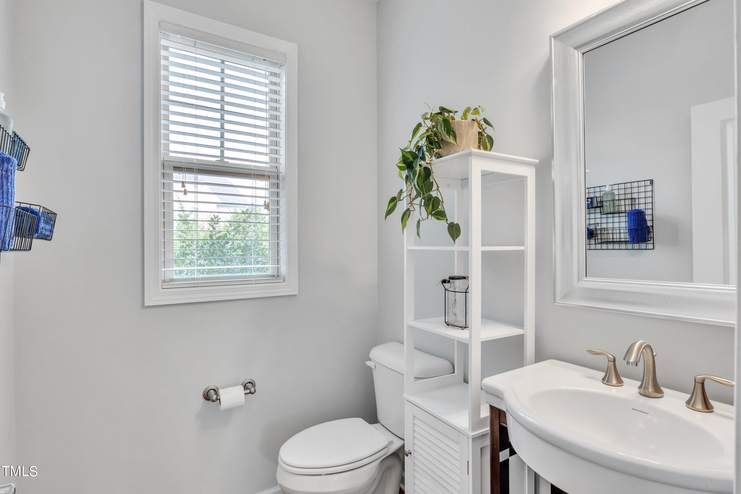 844 Wildflower Ridge Road Wake Forest, NC 27587 - Photo 14 of 66 a bathroom with a toilet sink and mirror