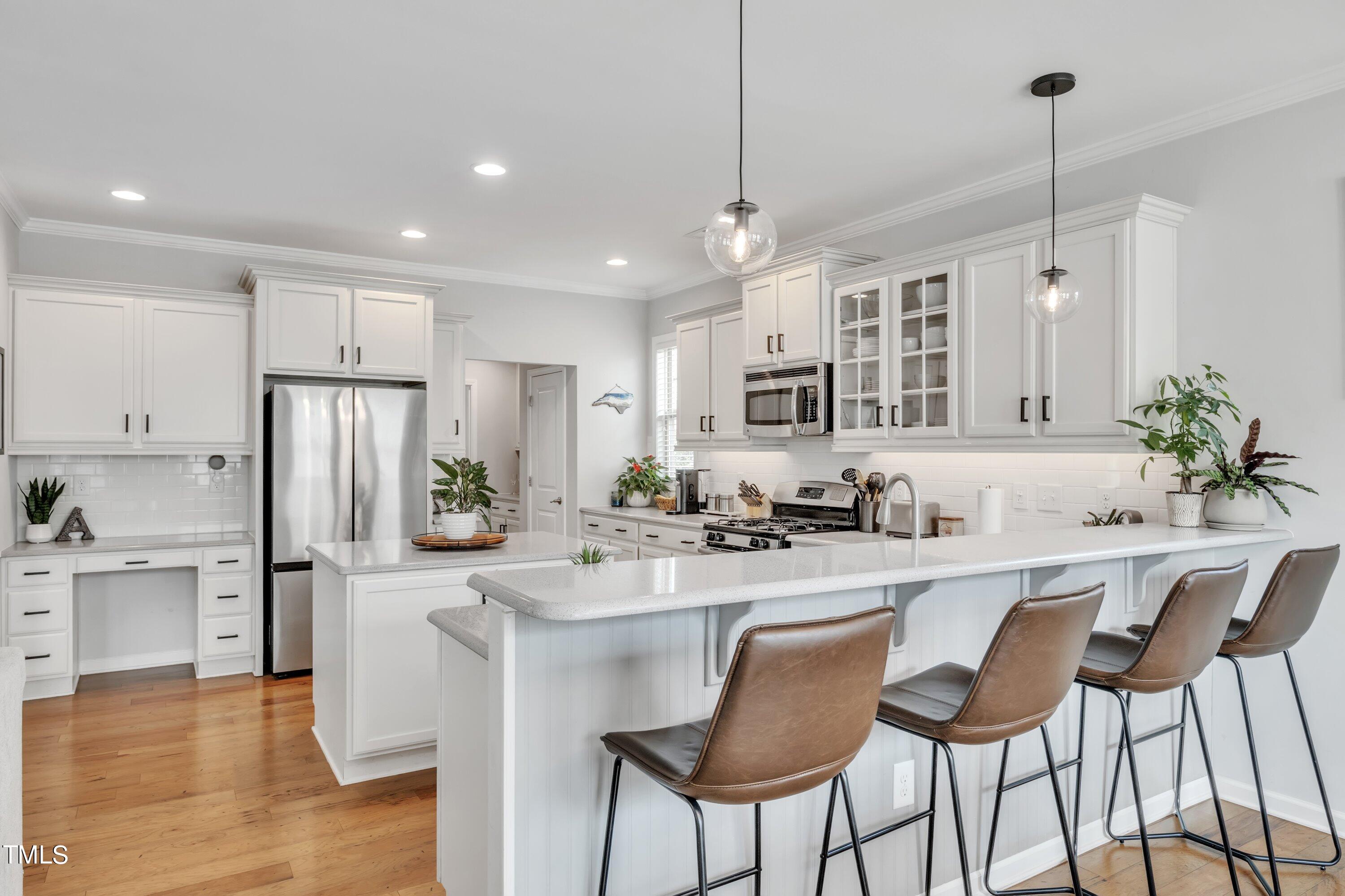 844 Wildflower Ridge Road Wake Forest, NC 27587 - Photo 17 of 66 a kitchen with granite countertop a center island a sink stainless steel appliances and cabinets