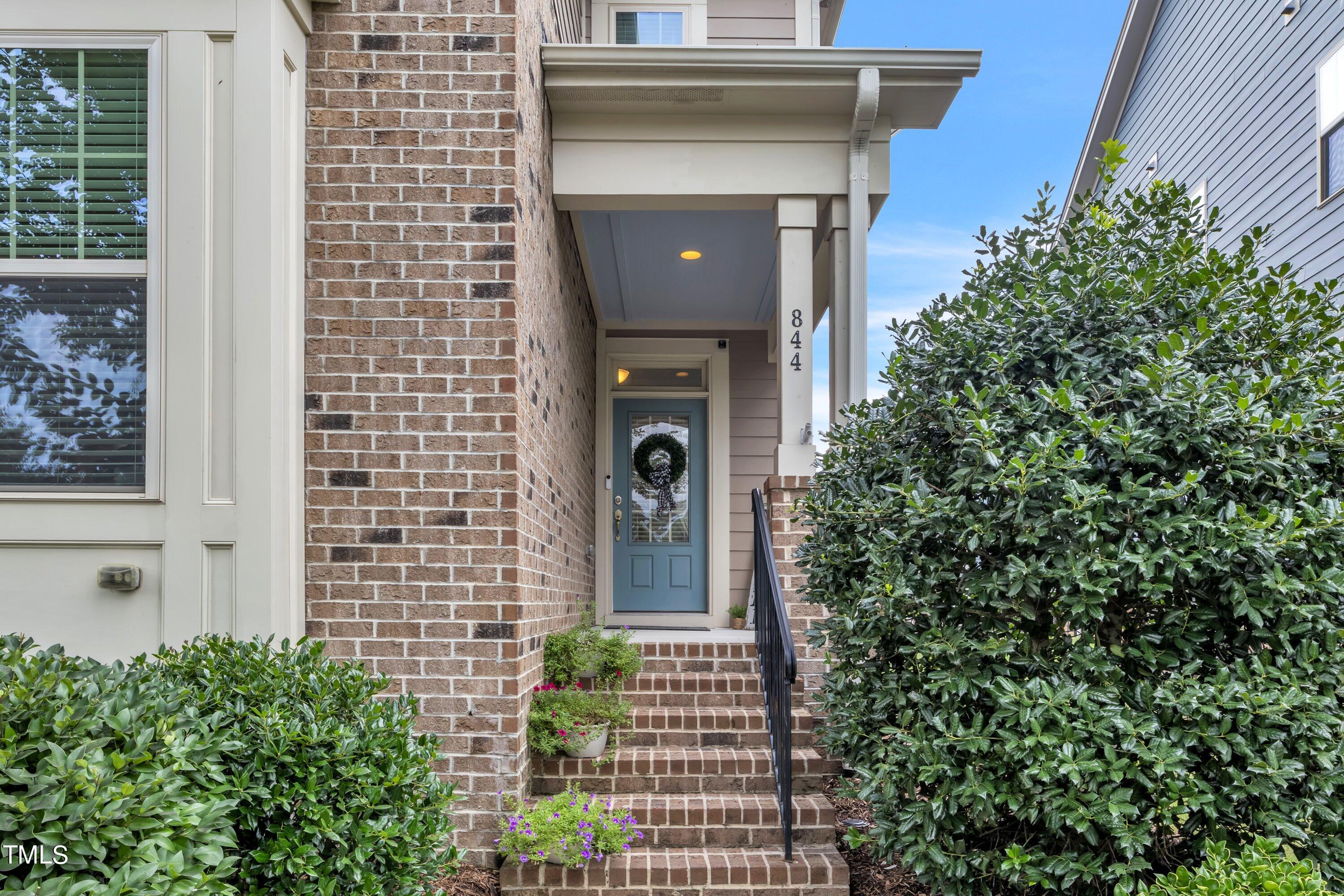 844 Wildflower Ridge Road Wake Forest, NC 27587 - Photo 2 of 66 a front view of a house with a tree