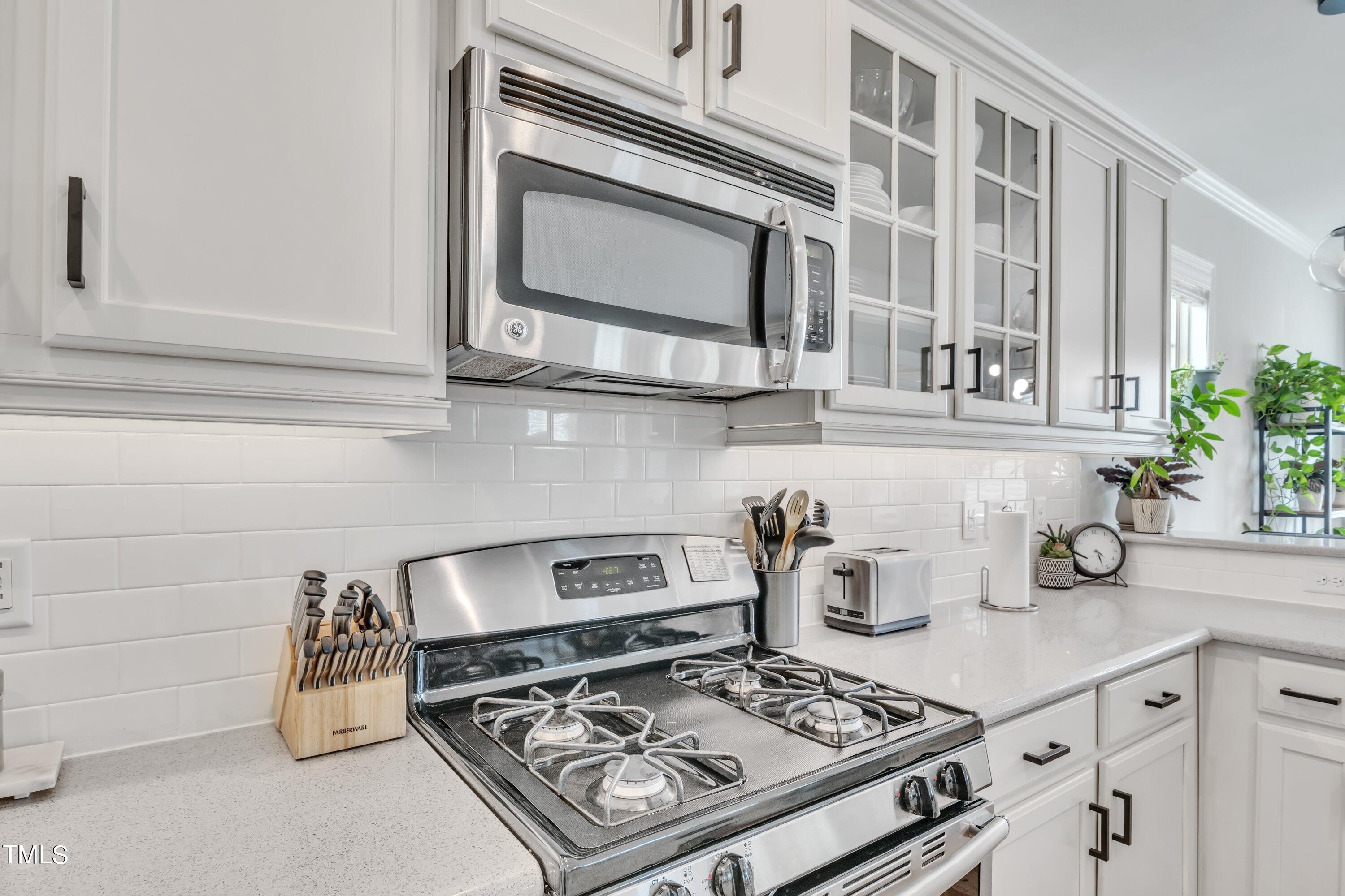 844 Wildflower Ridge Road Wake Forest, NC 27587 - Photo 21 of 66 a kitchen with a stove and cabinets