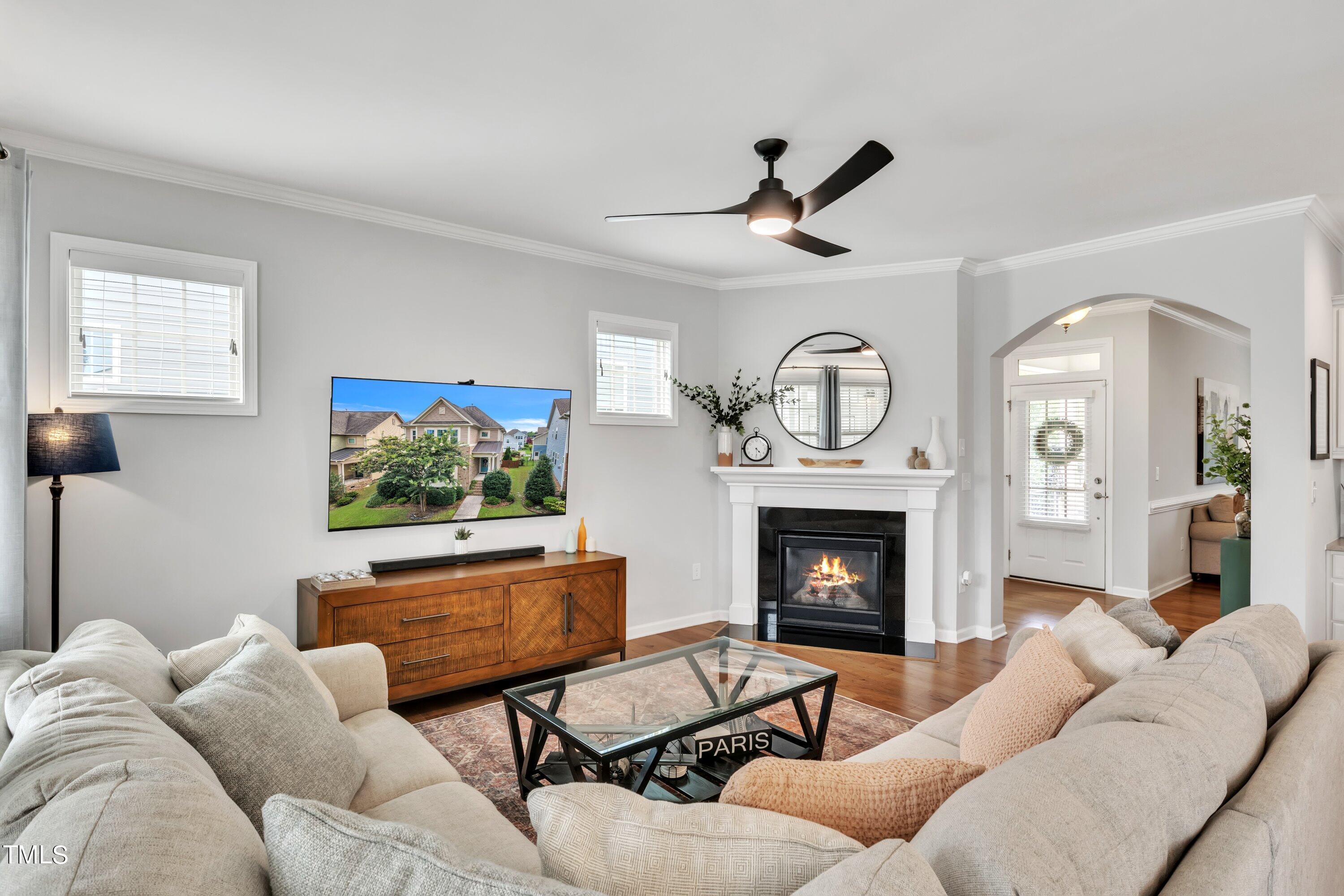 844 Wildflower Ridge Road Wake Forest, NC 27587 - Photo 26 of 66 a living room with furniture a fireplace and a flat screen tv