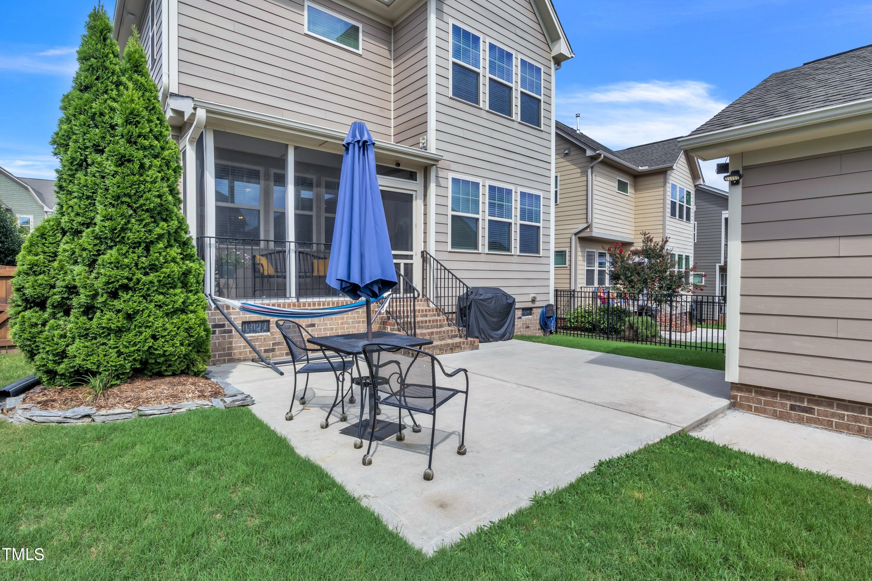 844 Wildflower Ridge Road Wake Forest, NC 27587 - Photo 47 of 66 a view of a patio with table and chairs and potted plants