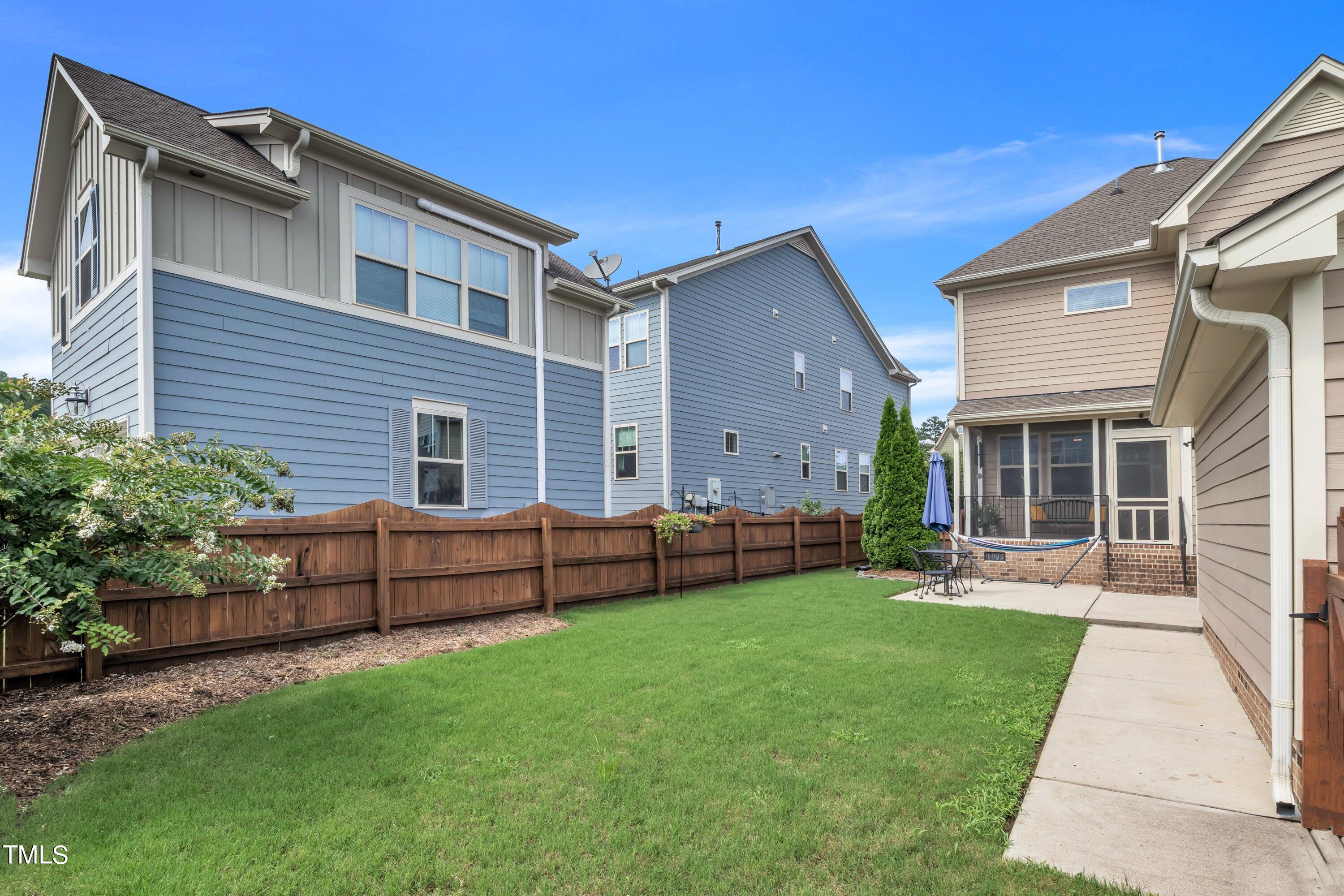 844 Wildflower Ridge Road Wake Forest, NC 27587 - Photo 53 of 66 a front view of a house with a yard and porch