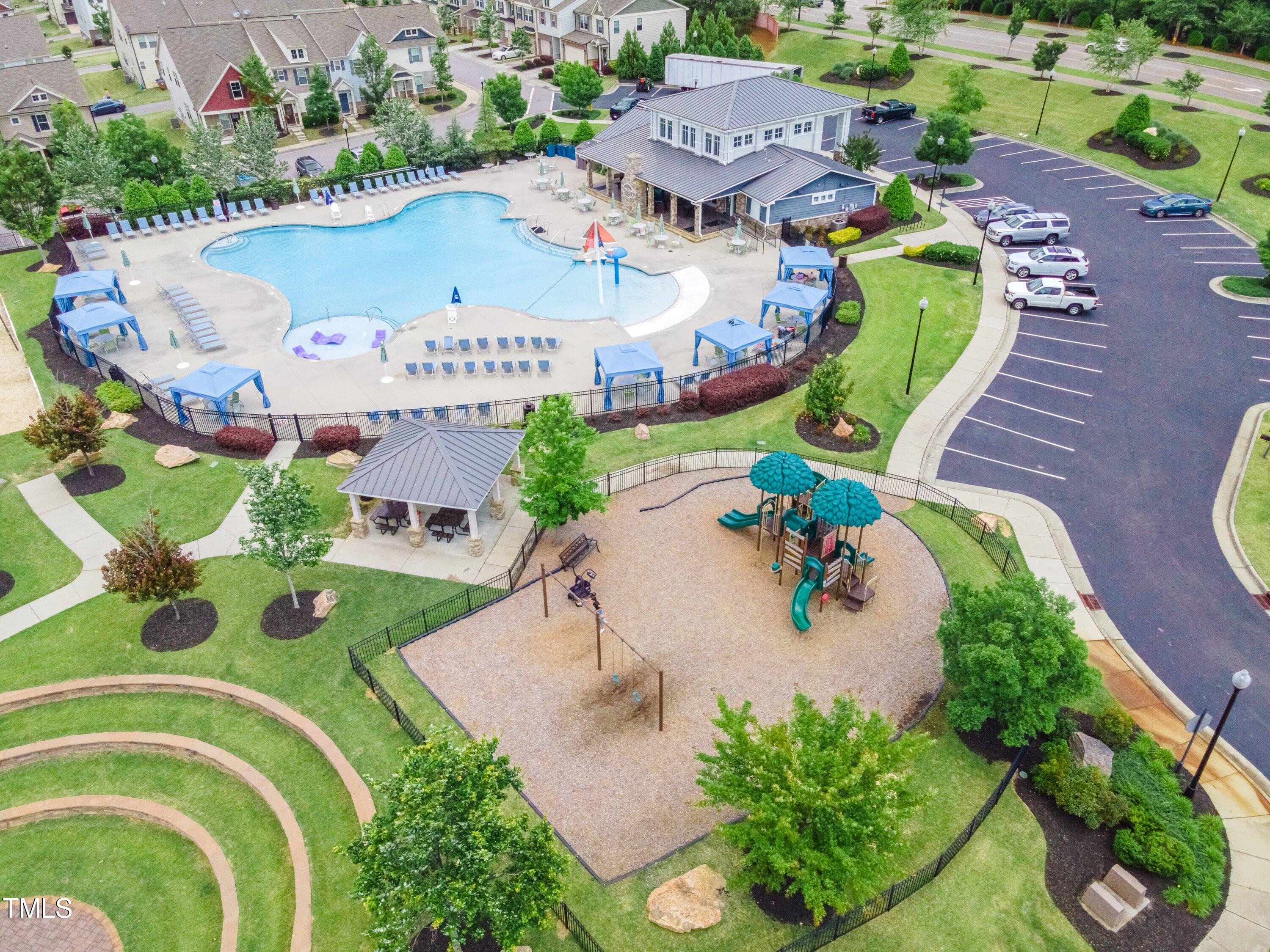 844 Wildflower Ridge Road Wake Forest, NC 27587 - Photo 64 of 66 an aerial view of a swimming pool with outdoor seating and yard