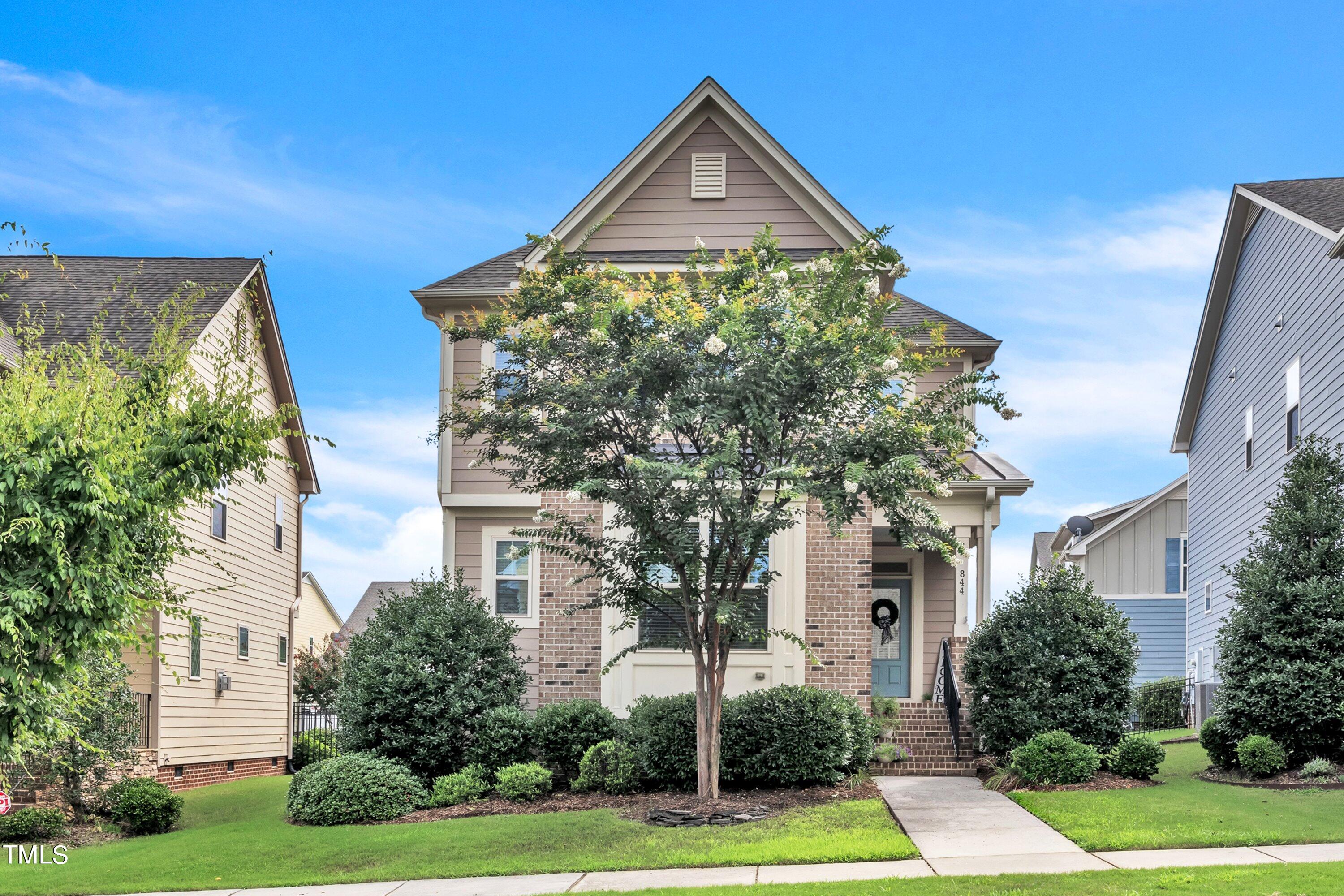 844 Wildflower Ridge Road Wake Forest, NC 27587 - Photo 8 of 66 a front view of a house with garden