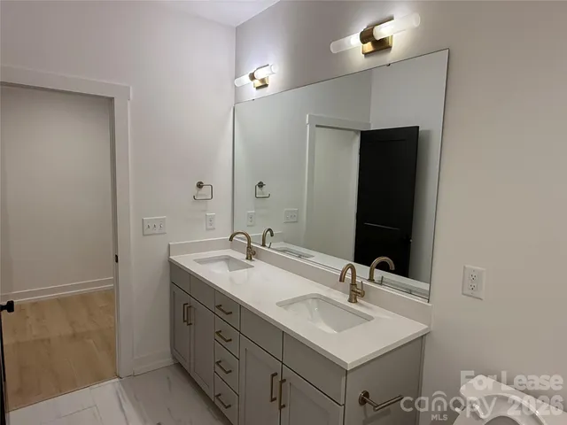 a bathroom with 2 sink and a mirror