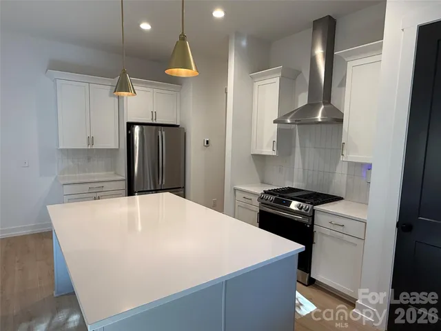 a kitchen with a stove and a refrigerator