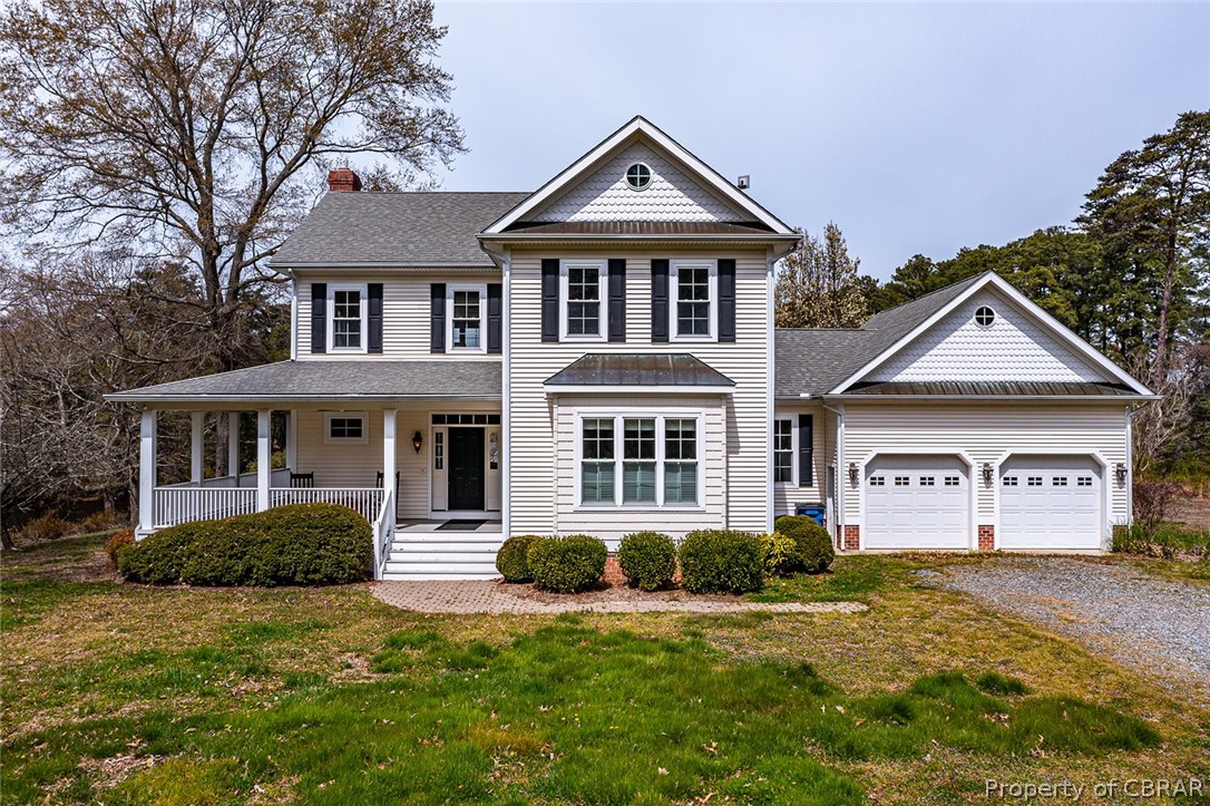 507 Sunnybank Road Reedville, VA 22539 - Photo 1 of 48 View of front of property with a garage, a porch, and a front lawn
