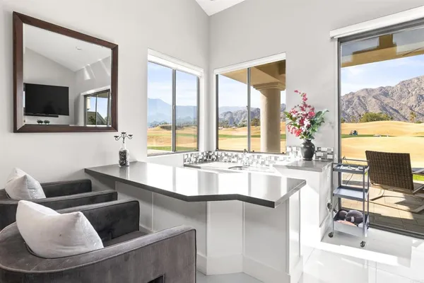 a large living room with a large window and a couch