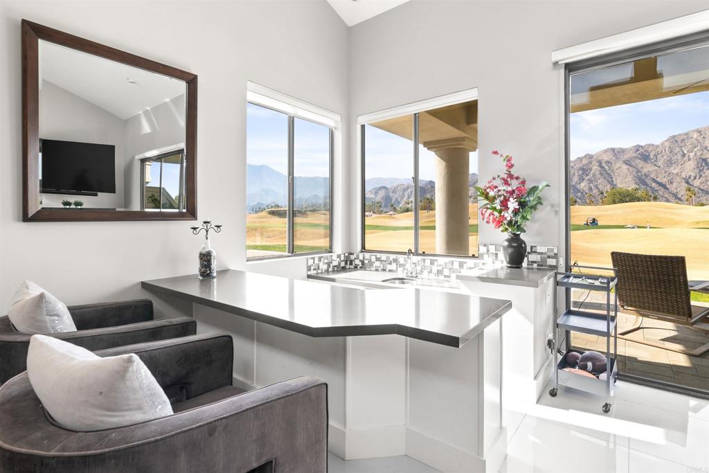 54877 Inverness Way La Quinta, CA 92253 - Photo 16 of 60 a large living room with a large window and a couch