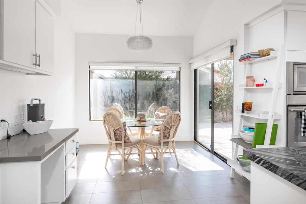 54877 Inverness Way La Quinta, CA 92253 - Photo 19 of 60 a dining room with furniture a chandelier and wooden floor