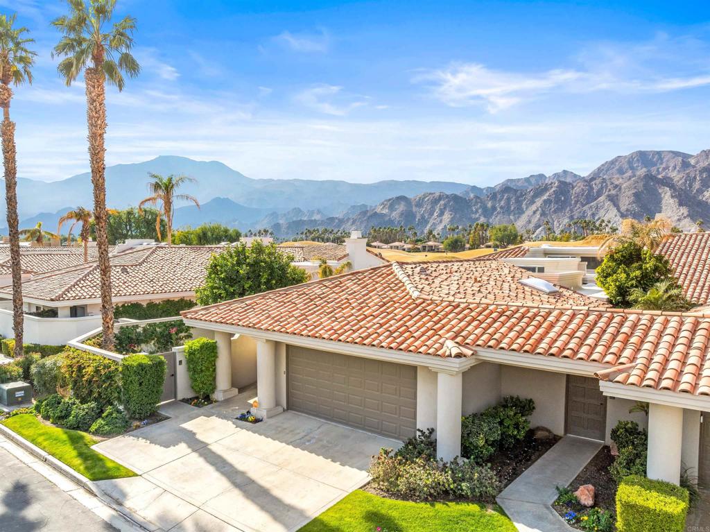 54877 Inverness Way La Quinta, CA 92253 - Photo 2 of 60 a front view of a house with a yard and lake view