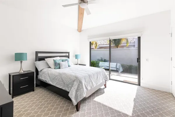 a bedroom with a bed and a lamp