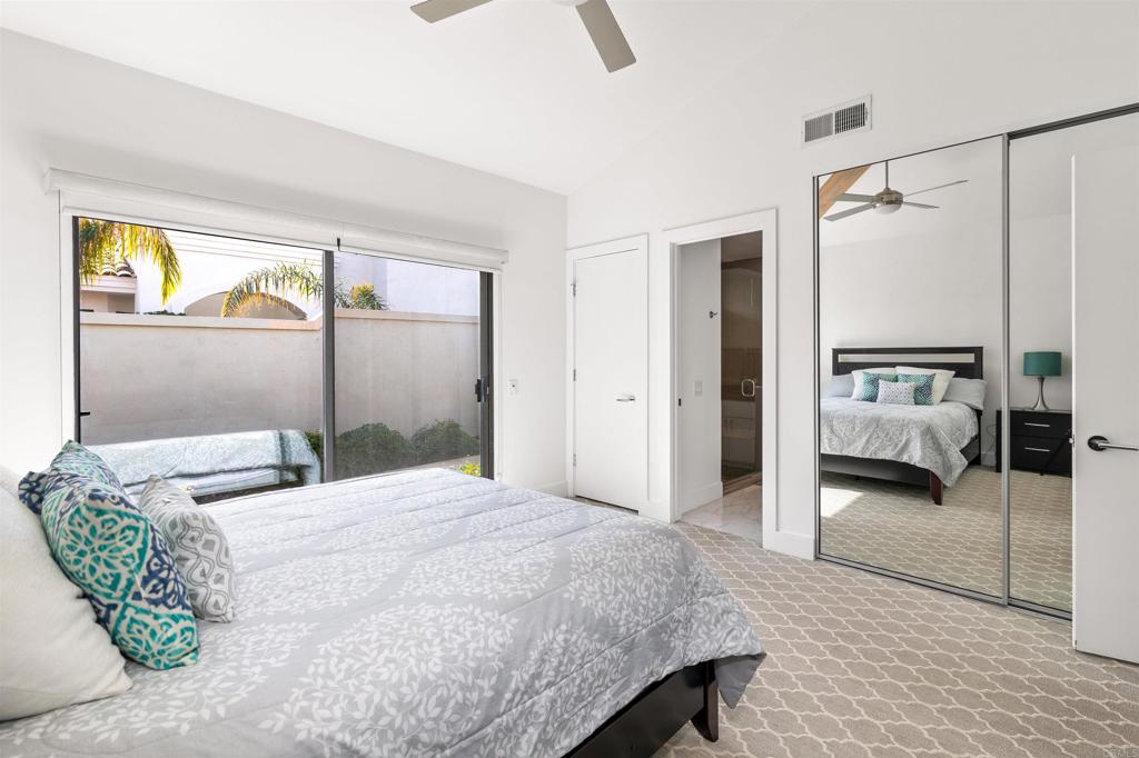 54877 Inverness Way La Quinta, CA 92253 - Photo 27 of 60 a bedroom with a bed and a mirror
