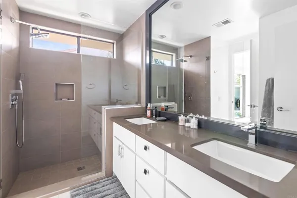 a bedroom with a bed lamp and a large window