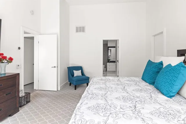 a bedroom with a bed and large flat screen tv