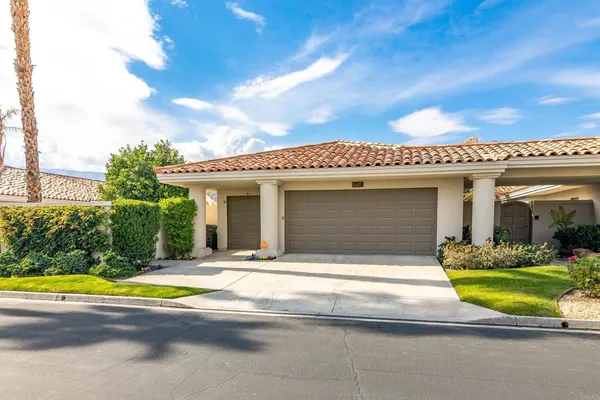 a view of a house with swimming pool and sitting area