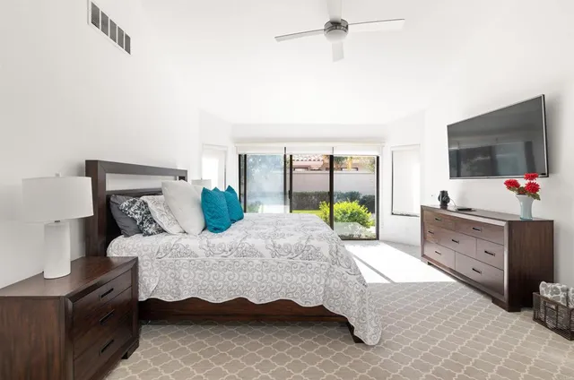 a white bath tub sitting in a bathroom and mirror