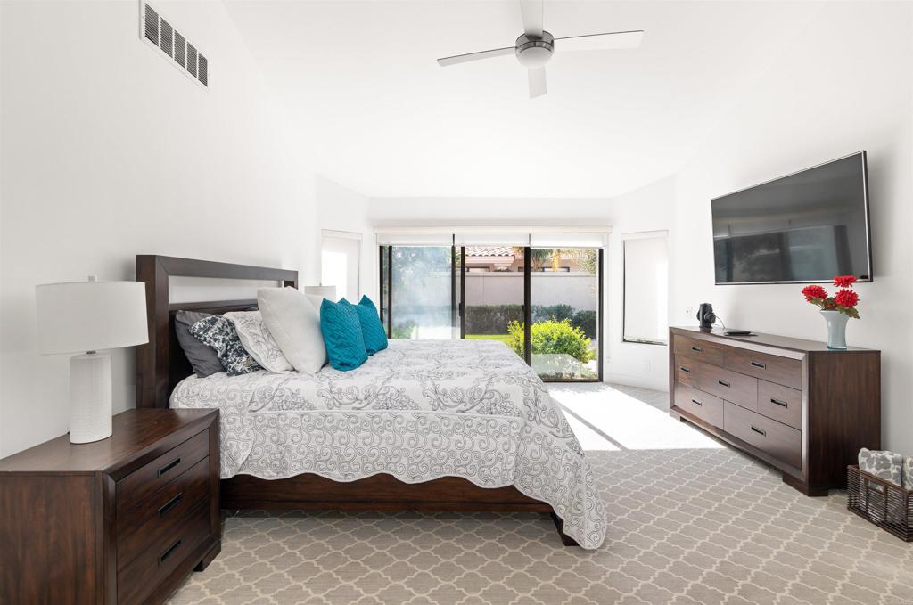 54877 Inverness Way La Quinta, CA 92253 - Photo 31 of 60 a bedroom with a bed and large flat screen tv