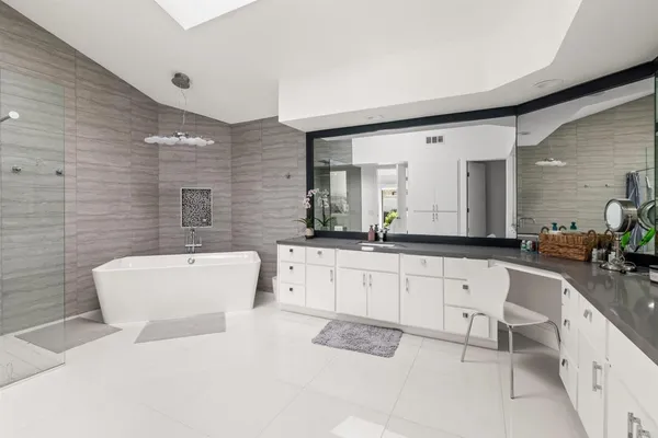 a bathroom with a sink a mirror and shower