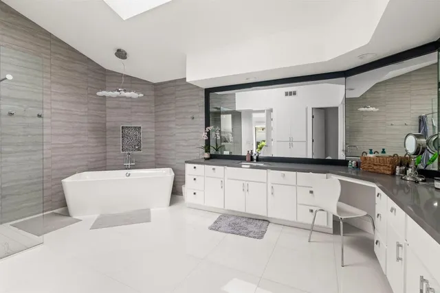 a bathroom with a sink a mirror and shower