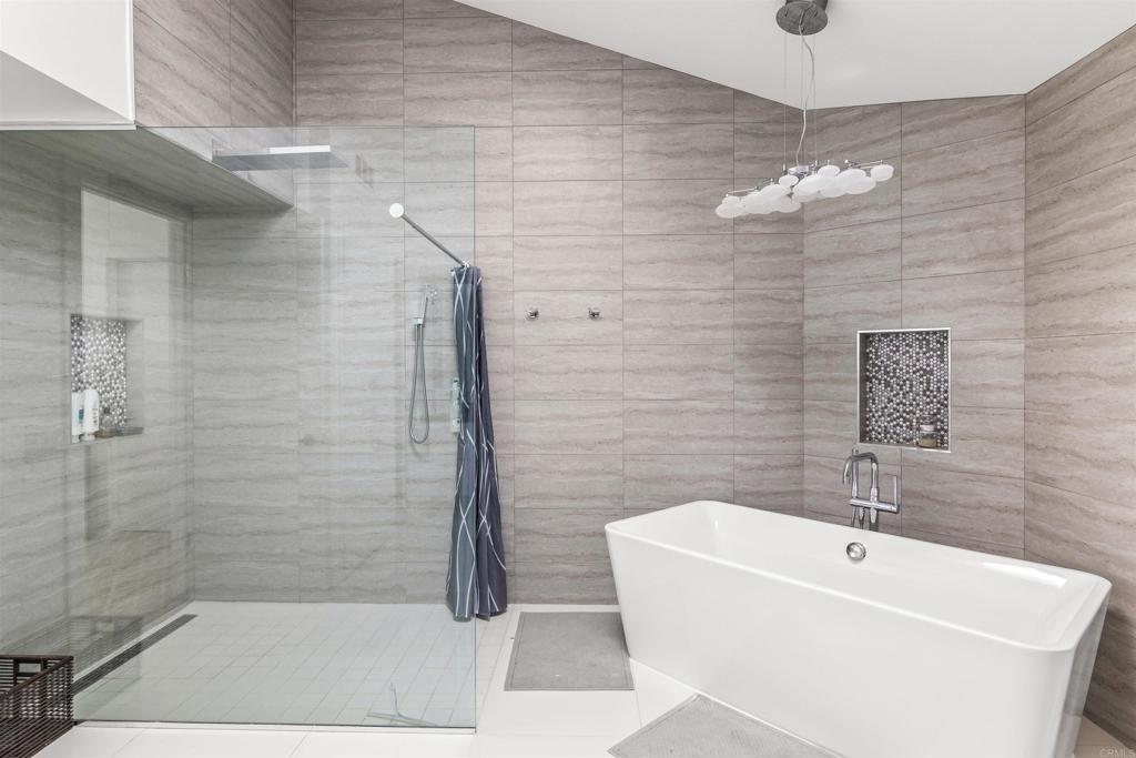 54877 Inverness Way La Quinta, CA 92253 - Photo 36 of 60 a bathroom with a sink a mirror and shower