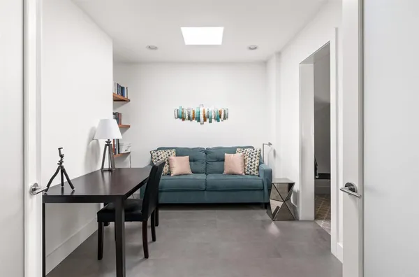 a view of a patio with lawn chairs floor to ceiling window and an outdoor space
