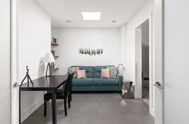 a view of a patio with lawn chairs floor to ceiling window and an outdoor space