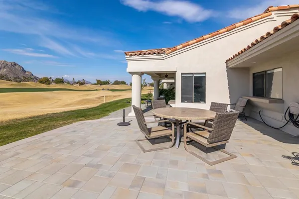 a view of a house with a yard patio and swimming pool