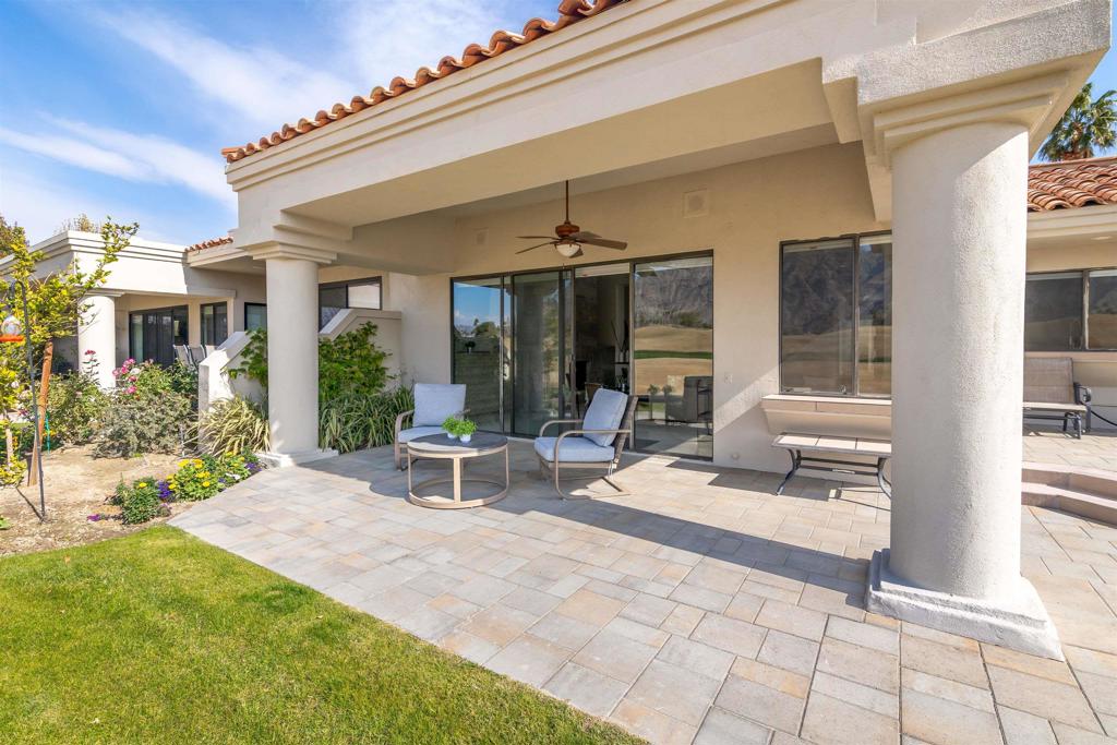 54877 Inverness Way La Quinta, CA 92253 - Photo 42 of 60 a view of a patio with table and chairs and potted plants