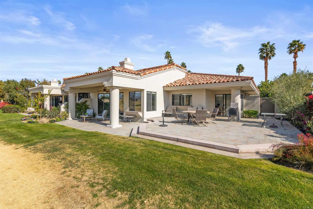 54877 Inverness Way La Quinta, CA 92253 - Photo 47 of 60 a view of a house with a patio and a garden