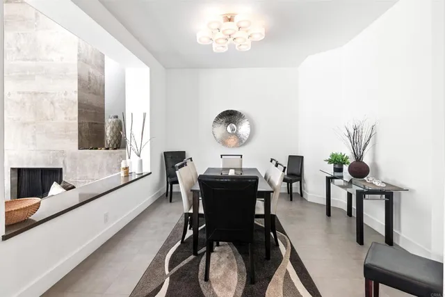 a view of a dining room with furniture and chandelier