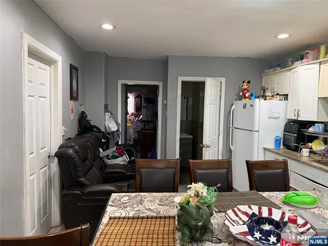 a living room with furniture fireplace and dining table
