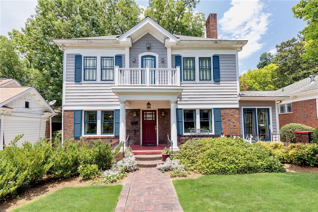 a front view of a house with a yard and porch