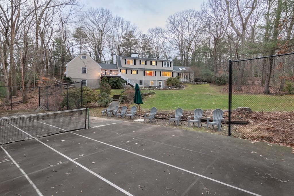 a view of a house with backyard and sitting area