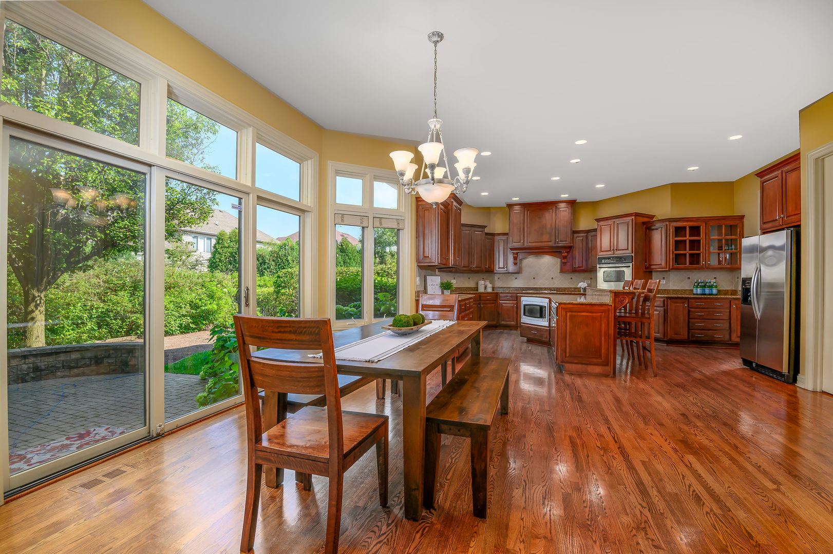 3416 Frankstowne Drive Naperville, IL 60565 - Photo 15 of 41 a view of a dining room and livingroom with furniture wooden floor a chandelier
